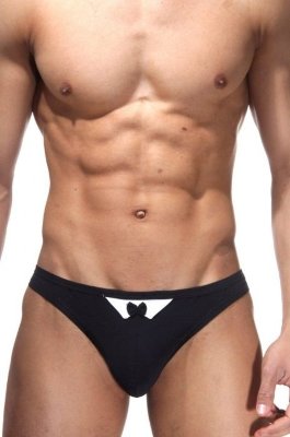 Трусы-стринги в стиле смокинга Классические трусы-стринги черного цвета. Спереди небольшая вставка белого цвета и маленький черный бант. Страна: Турция. Материал: 85% полиамид, 15% эластан.